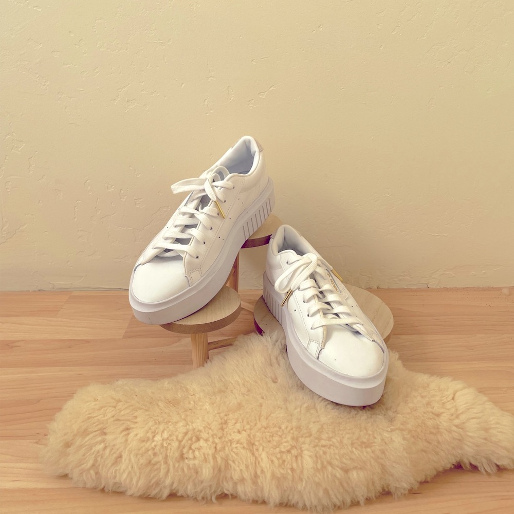 Adidas white leather sneakers with 1” soles. Excellent condition.
